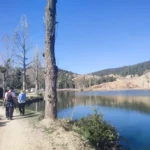 Hikers beside a mountain lake during a Middle Atlas trek